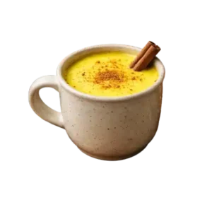 Warm turmeric milk before bed with turmeric powder and spices, traditional golden milk drink for sleep and wellness